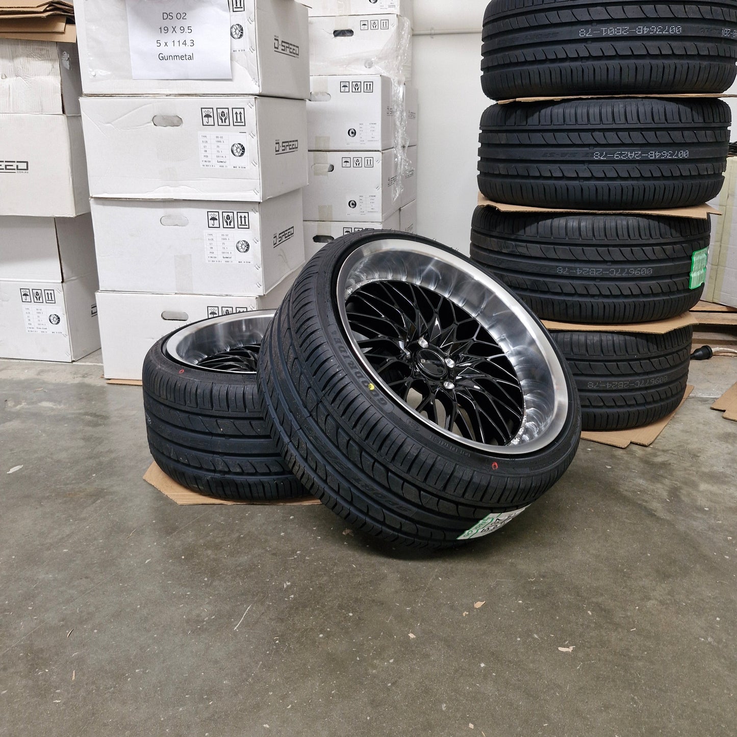 Tires stacked on top of boxes in a warehouse setting