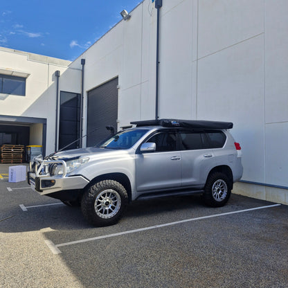 Silver SUV parked on a street with a building in the background