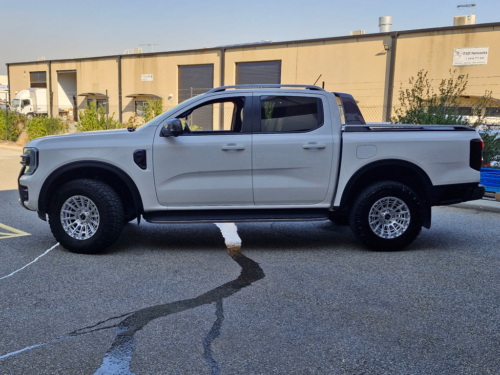 Car parked on a street with a clear blue sky ford ranger wildtrack next gen dspeed 4x4 wheels xt3 xt-3