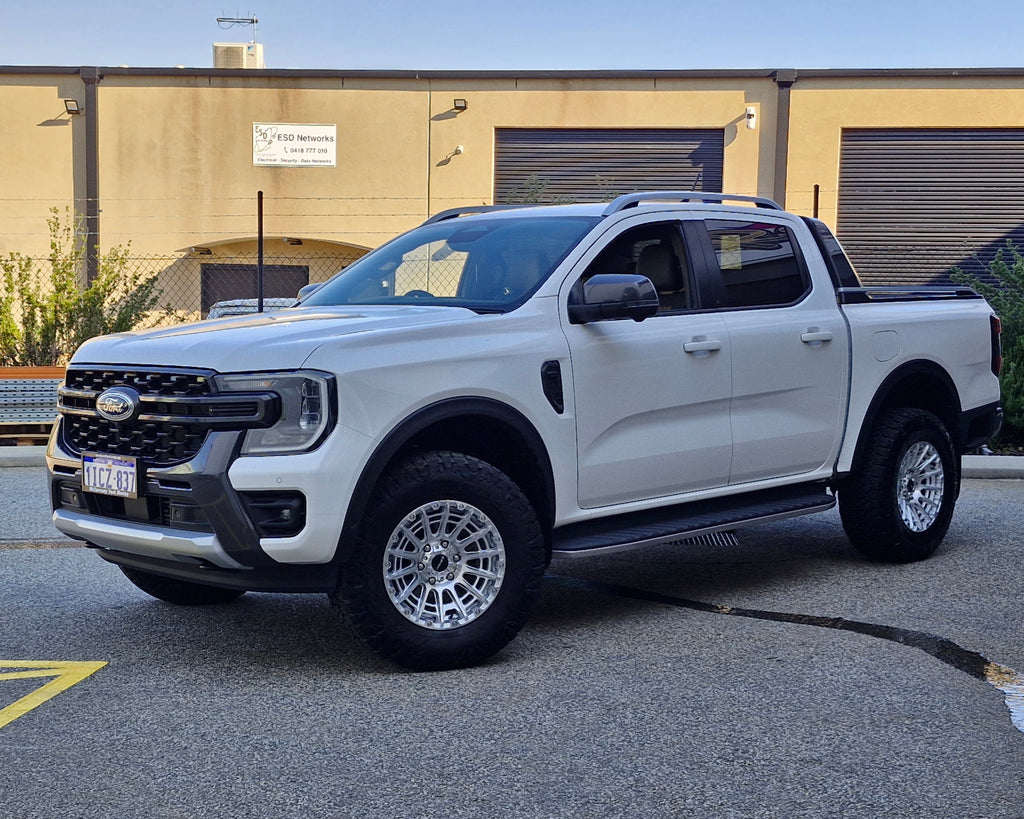 White Ford pickup truck parked in a lot with 4x4 wheels machined silver 17x8.5 500kg load rating high load rating gvm