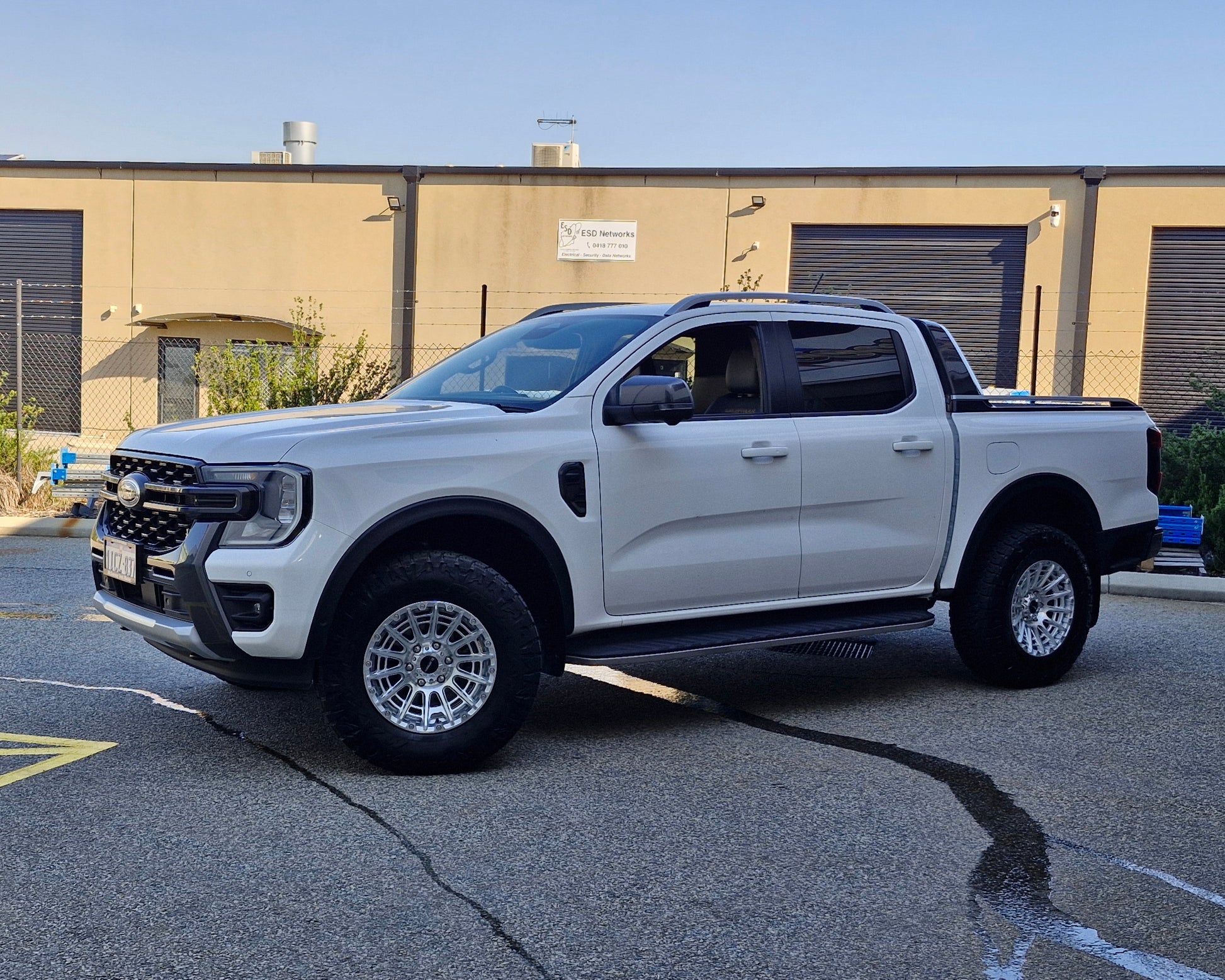 White Ford pickup truck parked in a lot with 4x4 wheels machined silver 17x8.5 500kg load rating high load rating gvm