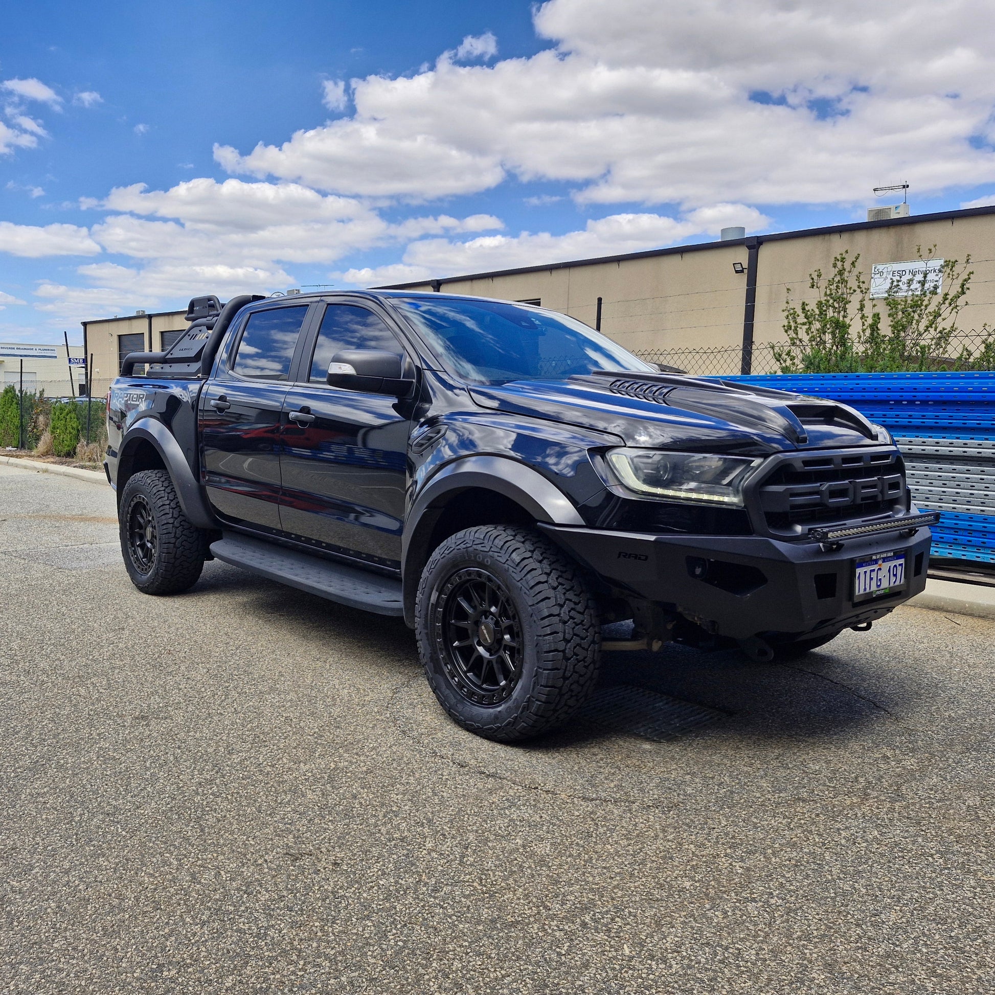 Black FORD RANGER RAPTOR parked on a street with a building in the background DSPEED XT1 XT-1 4X4 WHEELS