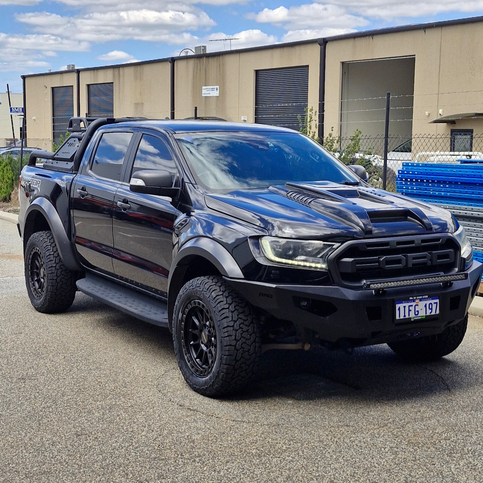 Black FORD RANGER RAPTOR parked on a street with a building in the background DSPEED XT1 XT-1 4X4 WHEELS