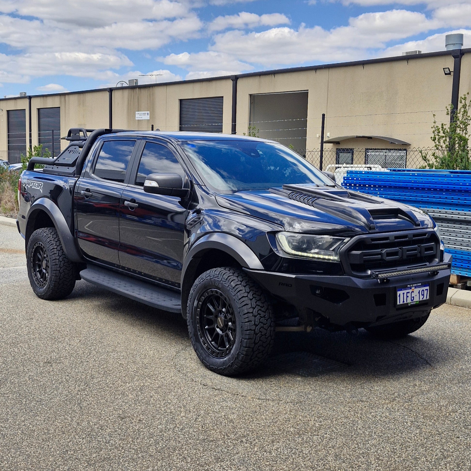 Black FORD RANGER RAPTOR parked on a street with a building in the background DSPEED XT1 XT-1 4X4 WHEELS