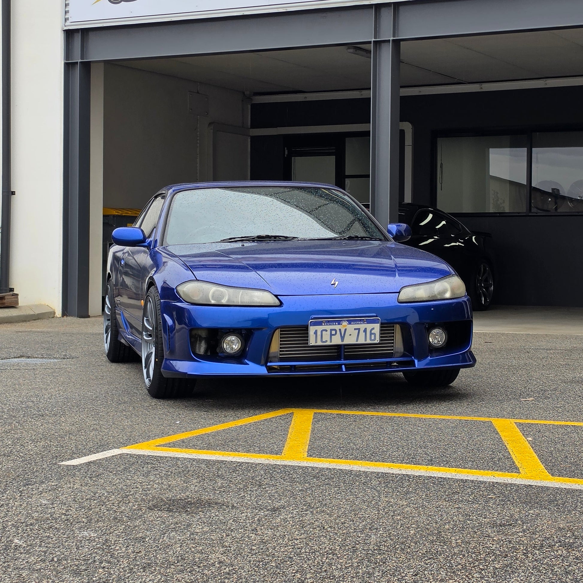 A blue Nissan 200sx s15 s13 s14 sports car parked on an asphalt DSpeed performance wheels D-Speed ds02 ds-02 wheels 18x8.5 +25 5x114.3 Gunmetal rims tyres wheel and tyre package