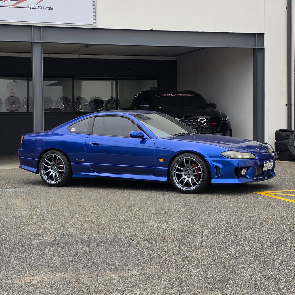 A blue Nissan 200sx s15 s13 s14 sports car parked on an asphalt DSpeed performance wheels D-Speed ds02 ds-02 wheels 18x8.5 +25 5x114.3 Gunmetal rims tyres wheel and tyre package