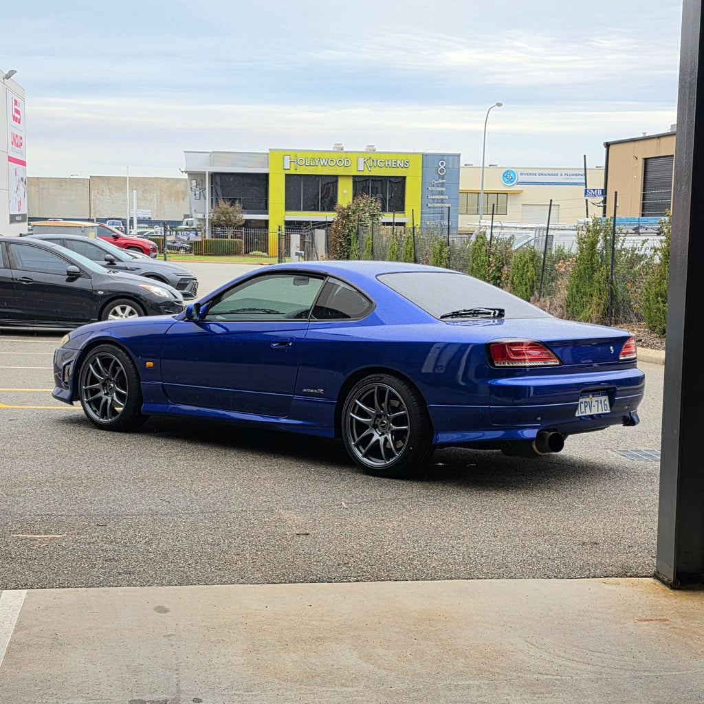 A blue Nissan 200sx s15 s13 s14 sports car parked on an asphalt DSpeed performance wheels D-Speed ds02 ds-02 wheels 18x8.5 +25 5x114.3 Gunmetal rims tyres wheel and tyre package