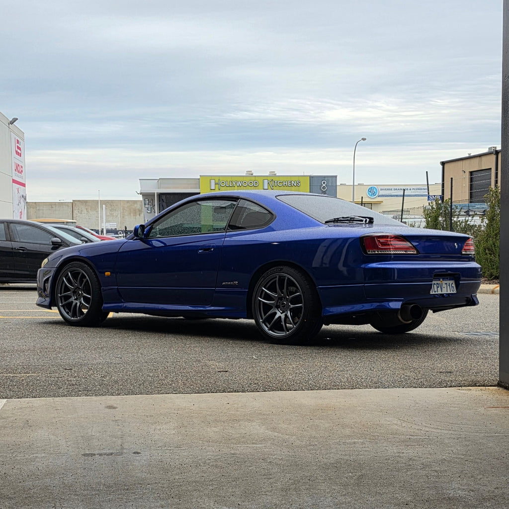 A blue Nissan 200sx s15 s13 s14 sports car parked on an asphalt DSpeed performance wheels D-Speed ds02 ds-02 wheels 18x8.5 +25 5x114.3 Gunmetal rims tyres wheel and tyre package