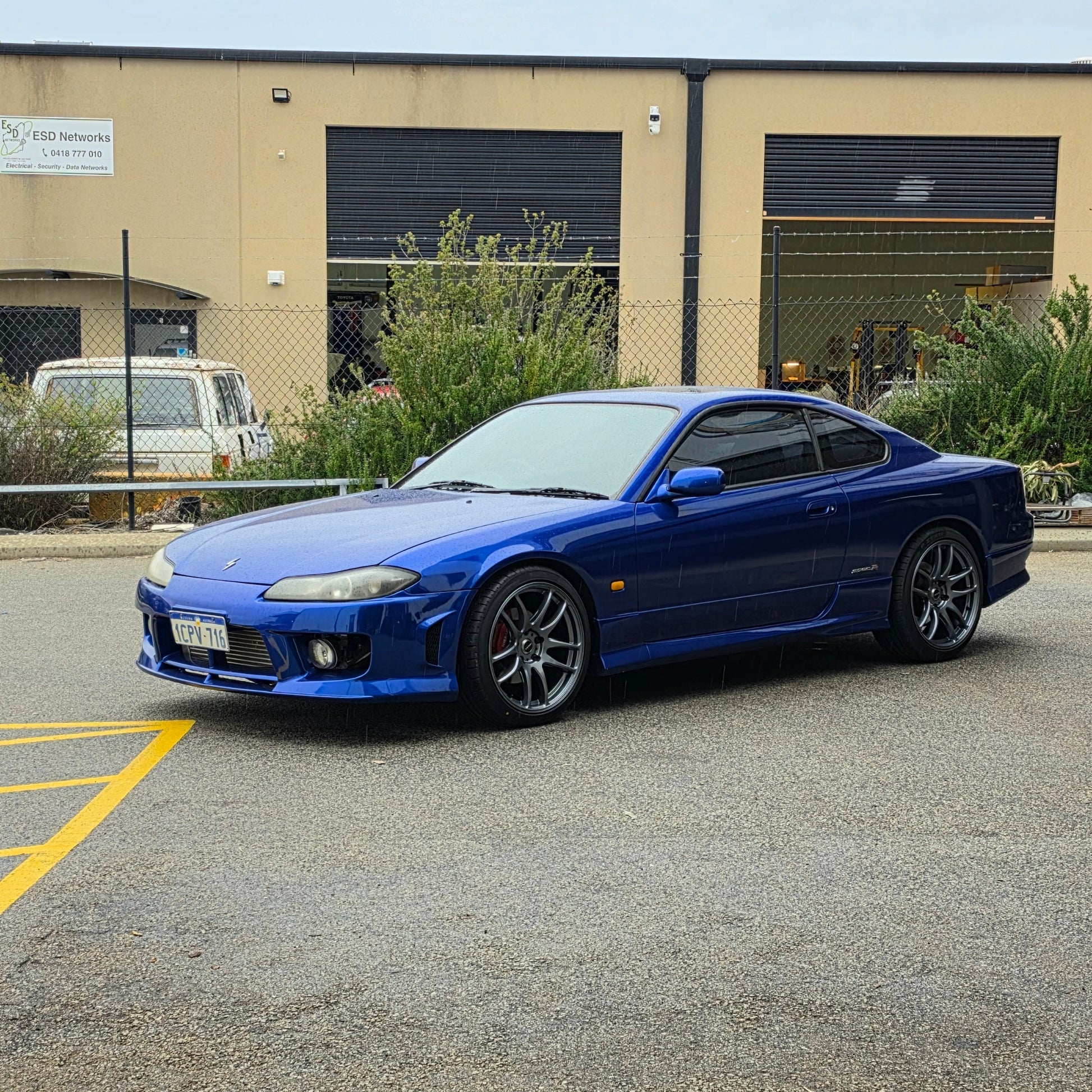 A blue Nissan 200sx s15 s13 s14 sports car parked on an asphalt DSpeed performance wheels D-Speed ds02 ds-02 wheels 18x8.5 +25 5x114.3 Gunmetal rims tyres wheel and tyre package