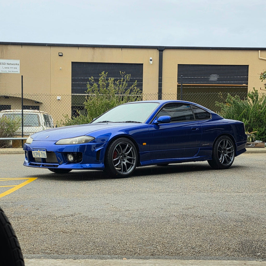 A blue Nissan 200sx s15 s13 s14 sports car parked on an asphalt DSpeed performance wheels D-Speed ds02 ds-02 wheels 18x8.5 +25 5x114.3 Gunmetal rims tyres wheel and tyre package