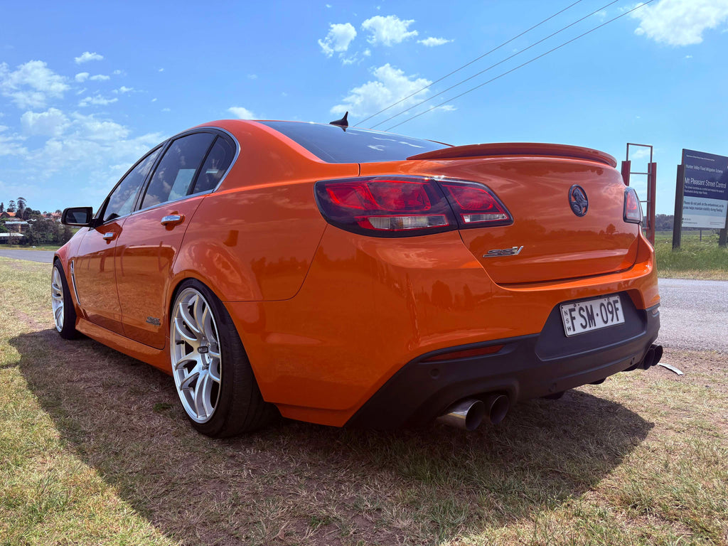 Orange car parked on grass with a clear blue sky dspeed ds02 19x9.5 wheels