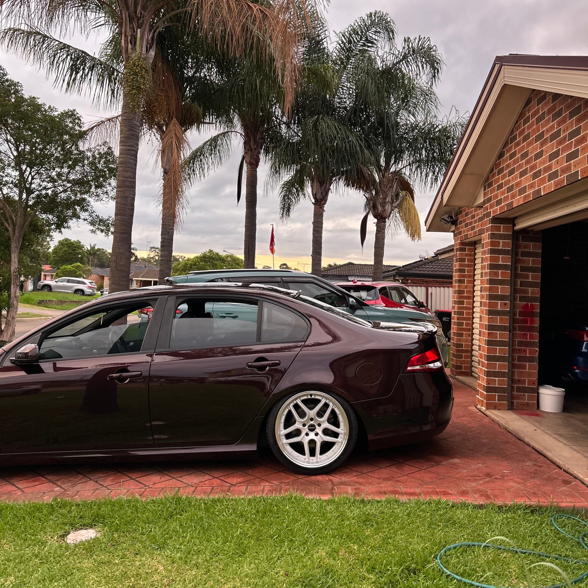 Black sedan car parked on a driveway with houses and palm trees in the background D-Speed DS-09 dspeed ds09 19inch wheels 19x9.5 silver dish alloy wheels