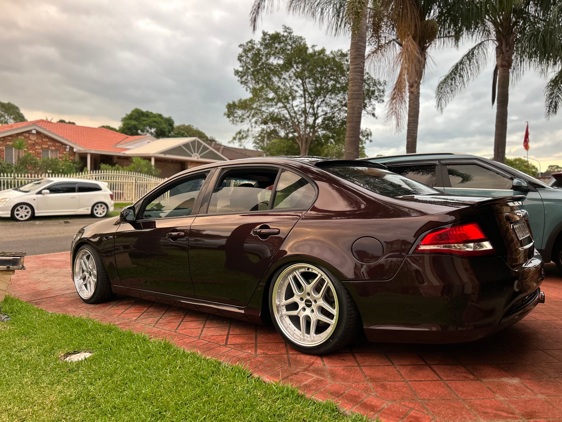 Black sedan car parked on a driveway with houses and palm trees in the background D-Speed DS-09 dspeed ds09 19inch wheels 19x9.5 silver dish alloy wheels