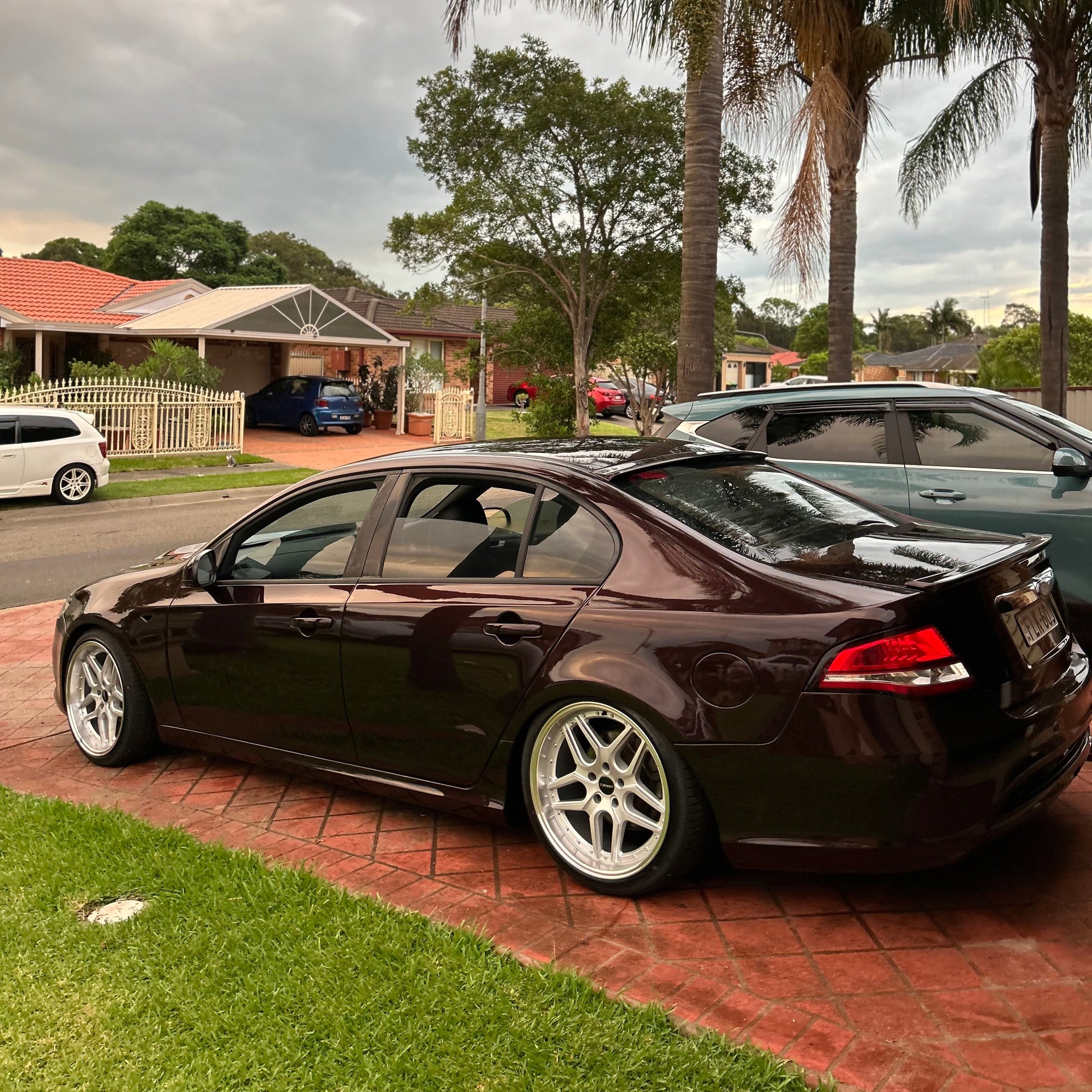 Black sedan car parked on a driveway with houses and palm trees in the background D-Speed DS-09 dspeed ds09 19inch wheels 19x9.5 silver dish alloy wheels