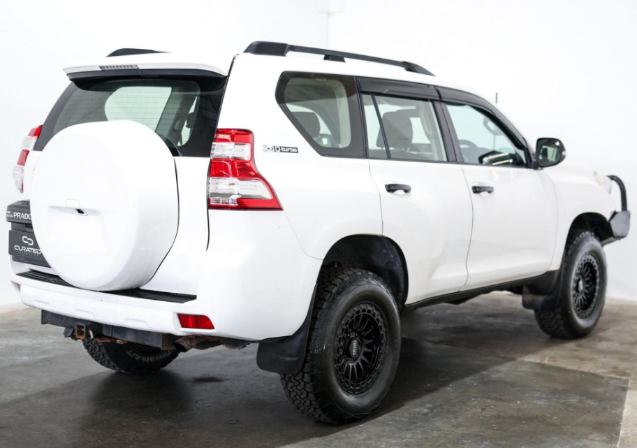 A white Toyota Land Cruiser PRADO SUV with a black front bumper guard, auxiliary lights, and off-road tires, photographed in a studio setting. 4X4 WHEELS DSPEED OFFROAD Off road MH-2 mh2 17x8.5 17inch 4x4 wheels rims deep dish black satin black