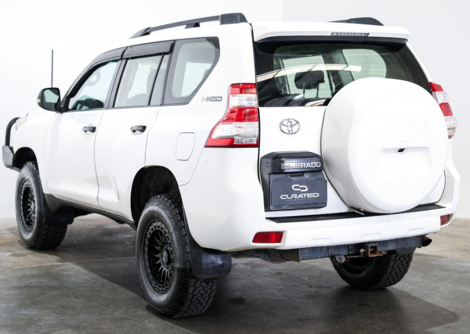 A white Toyota Land Cruiser PRADO SUV with a black front bumper guard, auxiliary lights, and off-road tires, photographed in a studio setting. 4X4 WHEELS DSPEED OFFROAD Off road MH-2 mh2 17x8.5 17inch 4x4 wheels rims deep dish black satin black