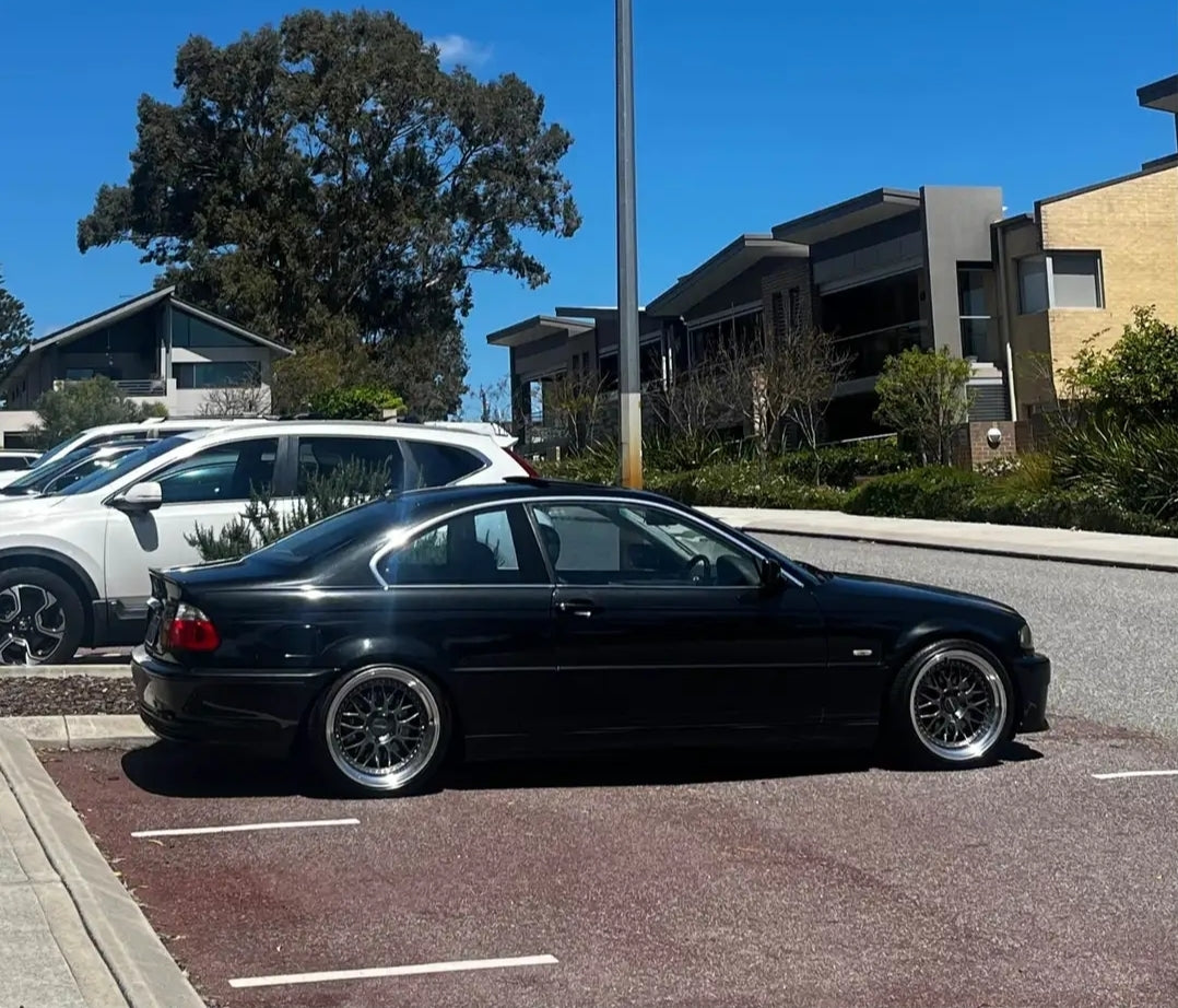 Black BMW car parked on a street with trees and another vehicle in the background DSpeed DS-6 ds06 wheels 18inch 18x8.5