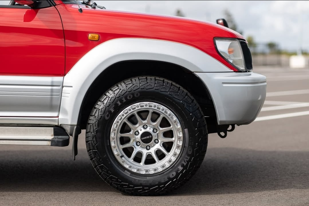 Red and silver SUV on a road with a cloudy sky dspeed xt-1 xt1 4x4 wheels