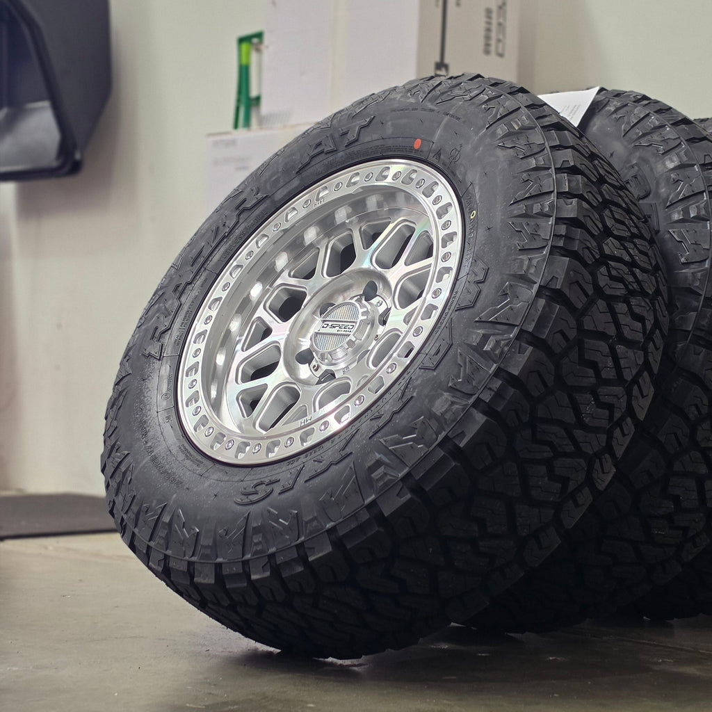 Two black off-road tires mounted on silver machined DSpeed d-speed MH01 mh1 mh-01 alloy wheels,17x8.5 17inch 4x4 wheels dished 1500kg load rating.