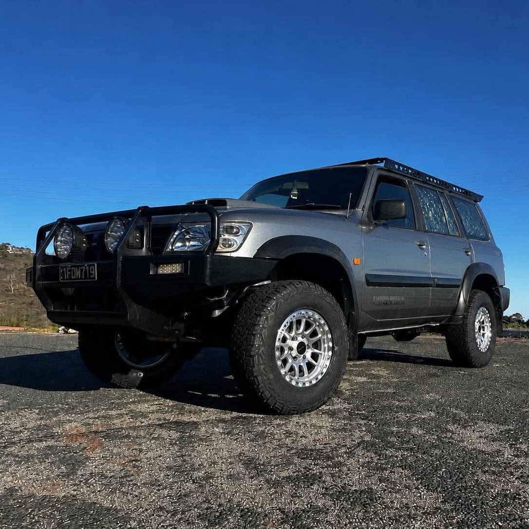 A silver lifted Nissan Patrol GU SUV with dspeed offroad off road t1 xt-1 wheels rims AT all terrain tyres 285/70R17 33inch 17x9 0 offset wheels
