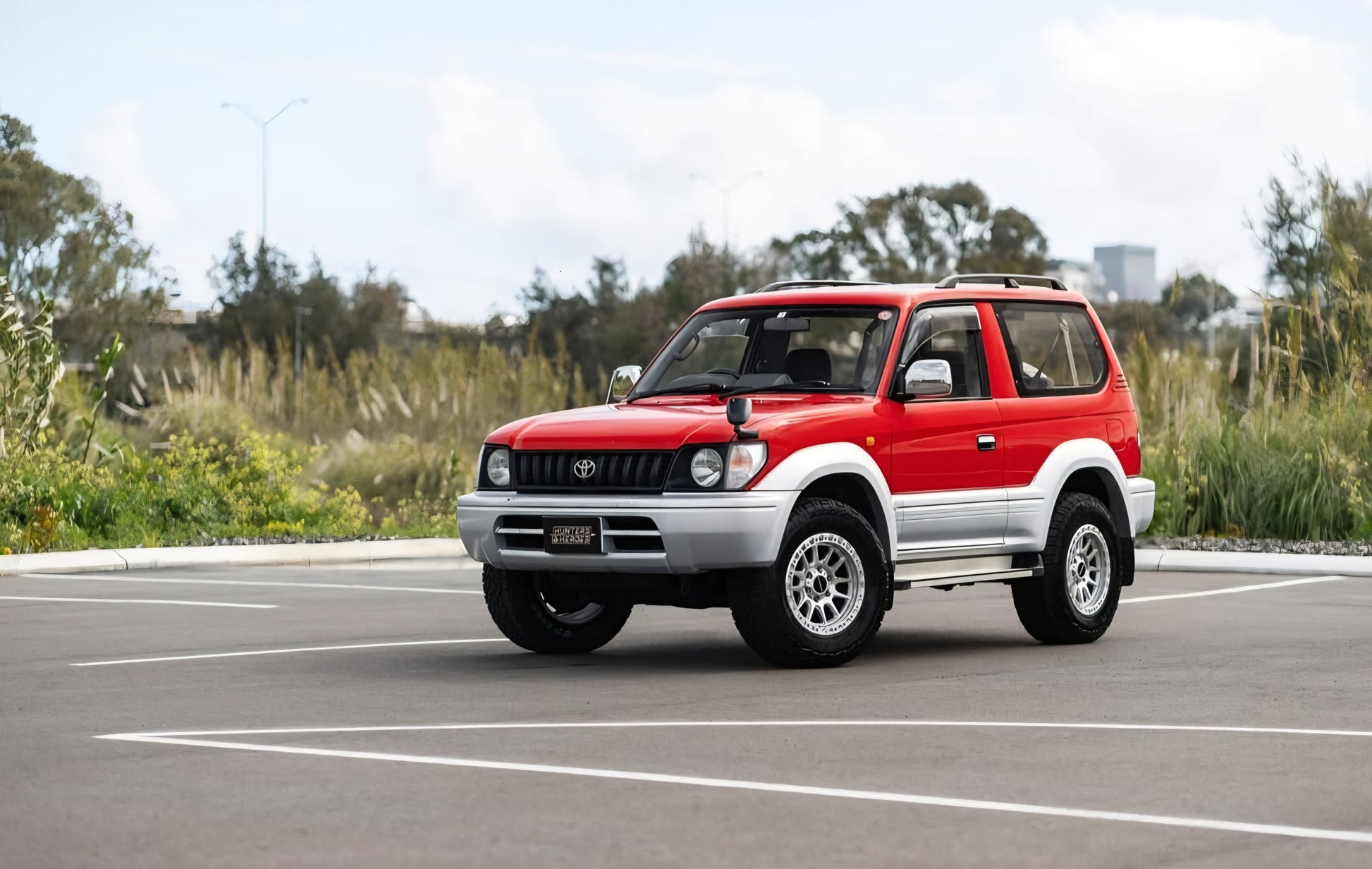 Red and silver SUV on a road with a cloudy sky dspeed xt-1 xt1 4x4 wheels