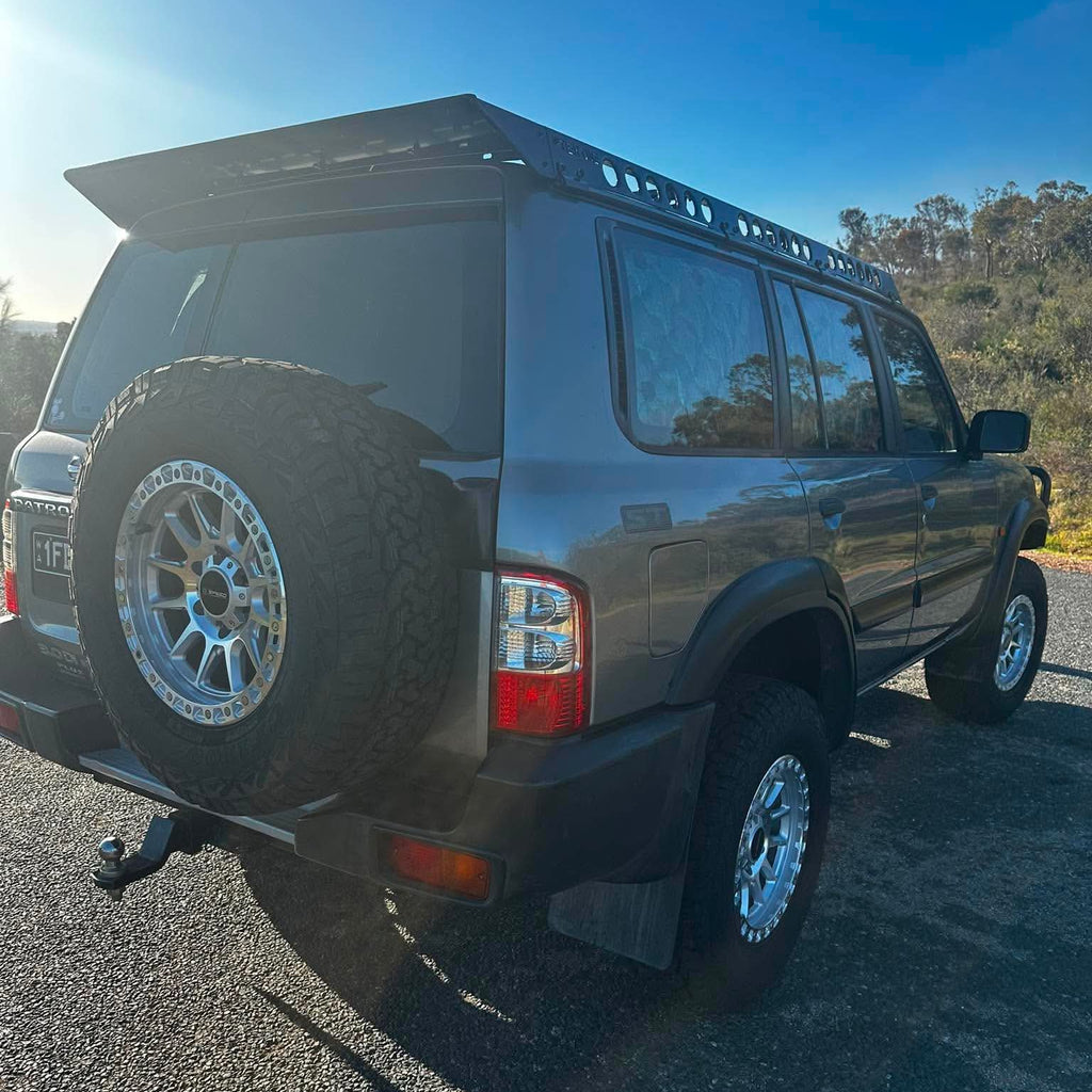 A silver lifted Nissan Patrol GU SUV with dspeed offroad off road t1 xt-1 wheels rims AT all terrain tyres 285/70R17 33inch 17x9 0 offset wheels