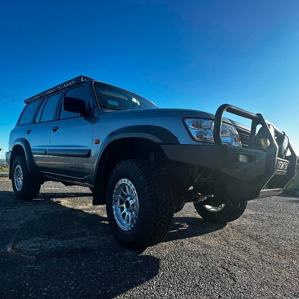 A silver lifted Nissan Patrol GU SUV with dspeed offroad off road t1 xt-1 wheels rims AT all terrain tyres 285/70R17 33inch 17x9 0 offset wheels