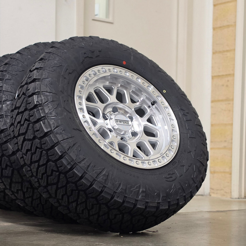 Two black off-road tires mounted on silver machined DSpeed d-speed MH01 mh1 mh-01 alloy wheels,17x8.5 17inch 4x4 wheels dished 1500kg load rating.