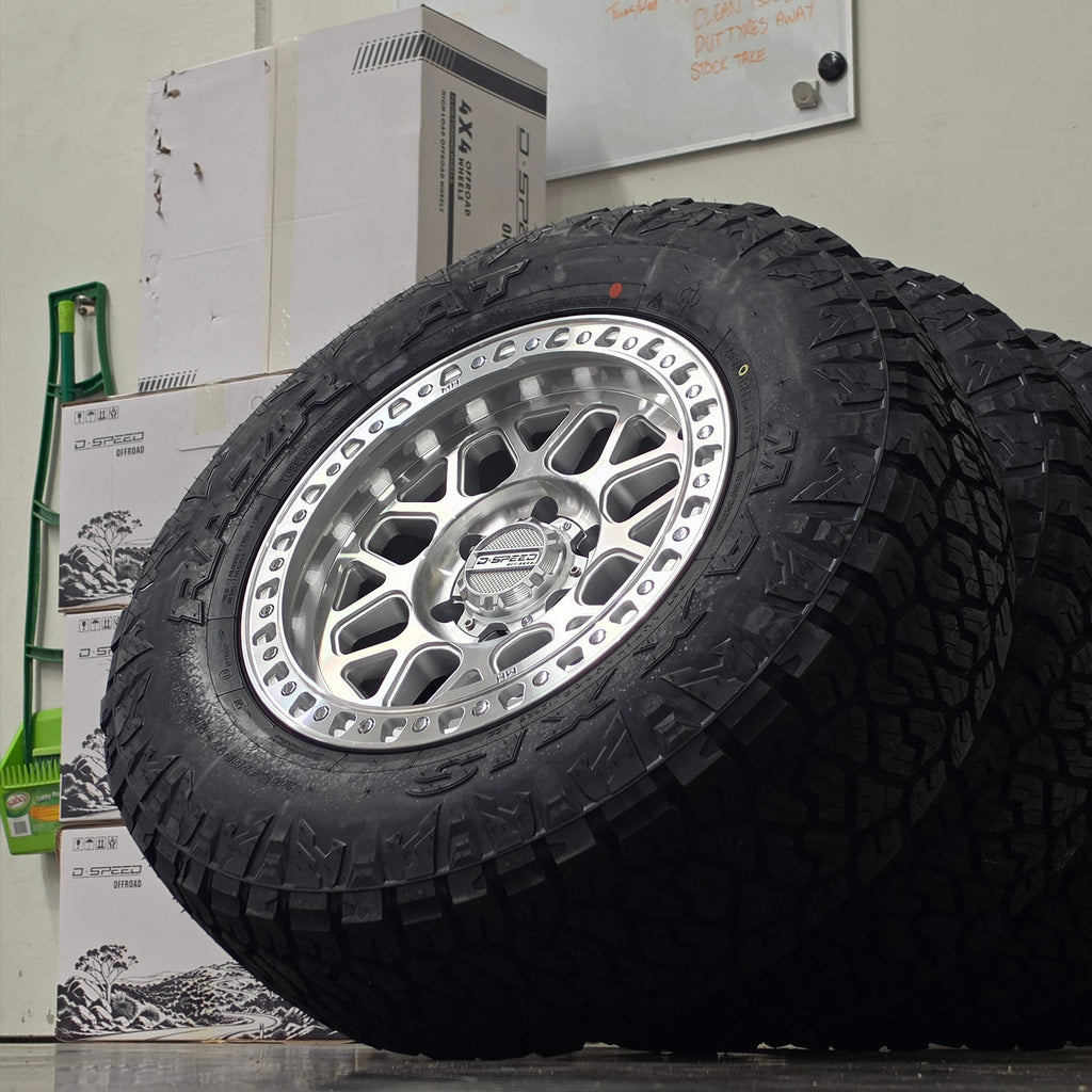 Two black off-road tires mounted on silver machined DSpeed d-speed MH01 mh1 mh-01 alloy wheels,17x8.5 17inch 4x4 wheels dished 1500kg load rating.