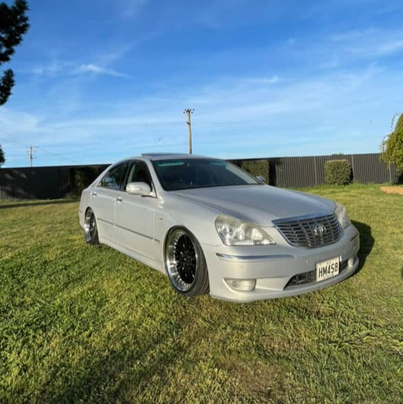 Silver car parked on grass with a clear blue sky toyota crown with 19x9.5 wheels Dspeed performance wheels