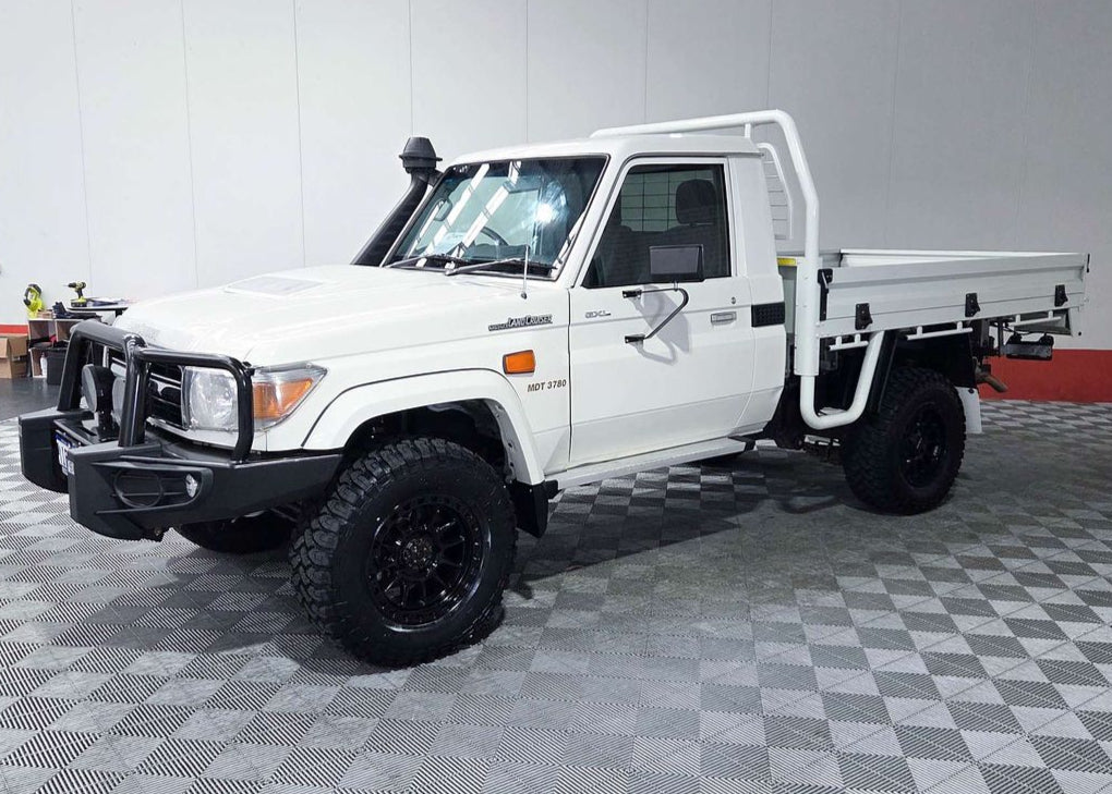 White pickup truck with a flatbed in a garage setting toyota landcruiser 79 series dspeed xt1 wheels