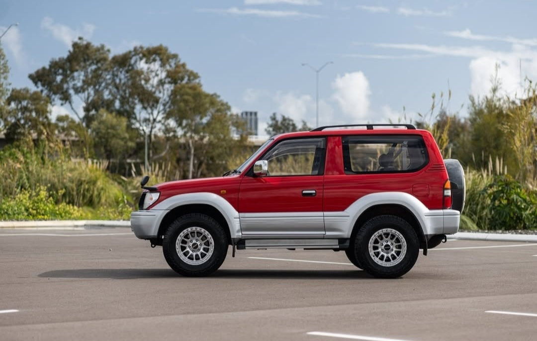 Red and silver SUV on a road with a cloudy sky dspeed xt-1 xt1 4x4 wheels