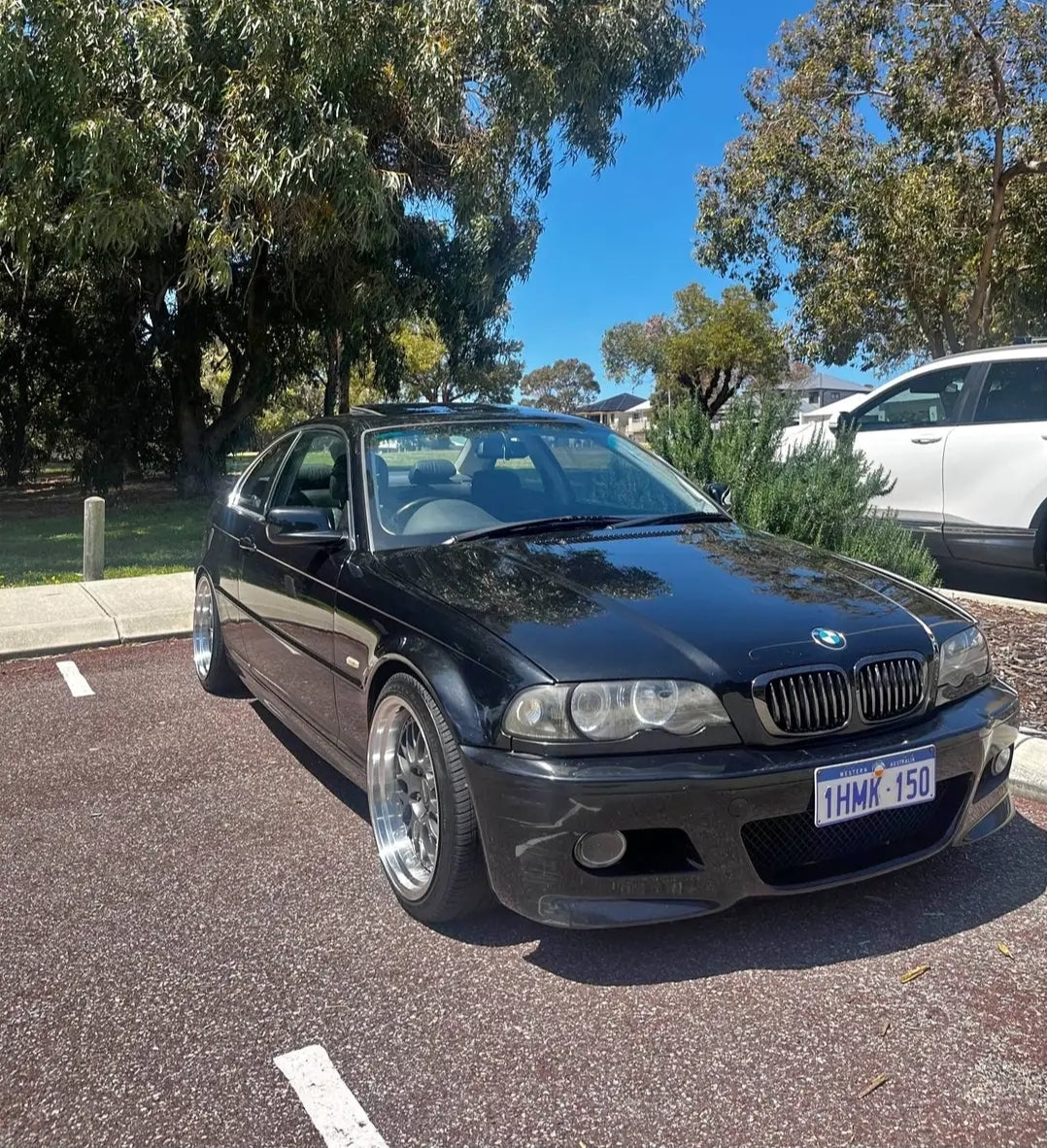 Black BMW car parked on a street with trees and another vehicle in the background DSpeed DS-6 ds06 wheels 18inch 18x8.5