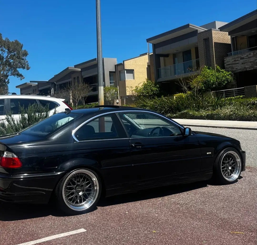 Black BMW car parked on a street with trees and another vehicle in the background DSpeed DS-6 ds06 wheels 18inch 18x8.5