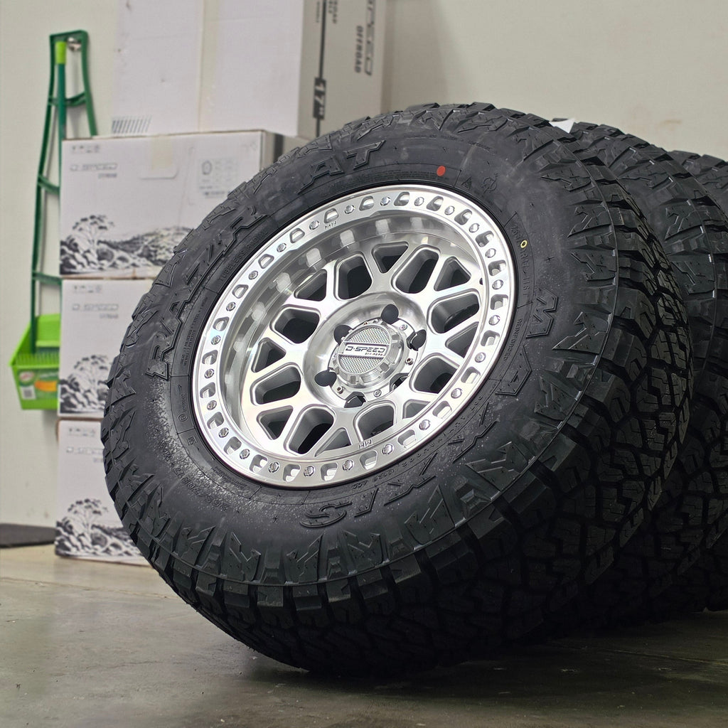 Two black off-road tires mounted on silver machined DSpeed d-speed MH01 mh1 mh-01 alloy wheels,17x8.5 17inch 4x4 wheels dished 1500kg load rating.