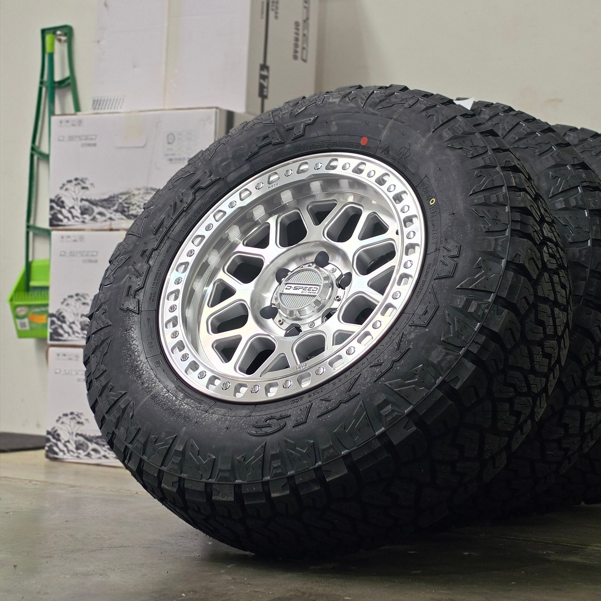 Two black off-road tires mounted on silver machined DSpeed d-speed MH01 mh1 mh-01 alloy wheels,17x8.5 17inch 4x4 wheels dished 1500kg load rating.