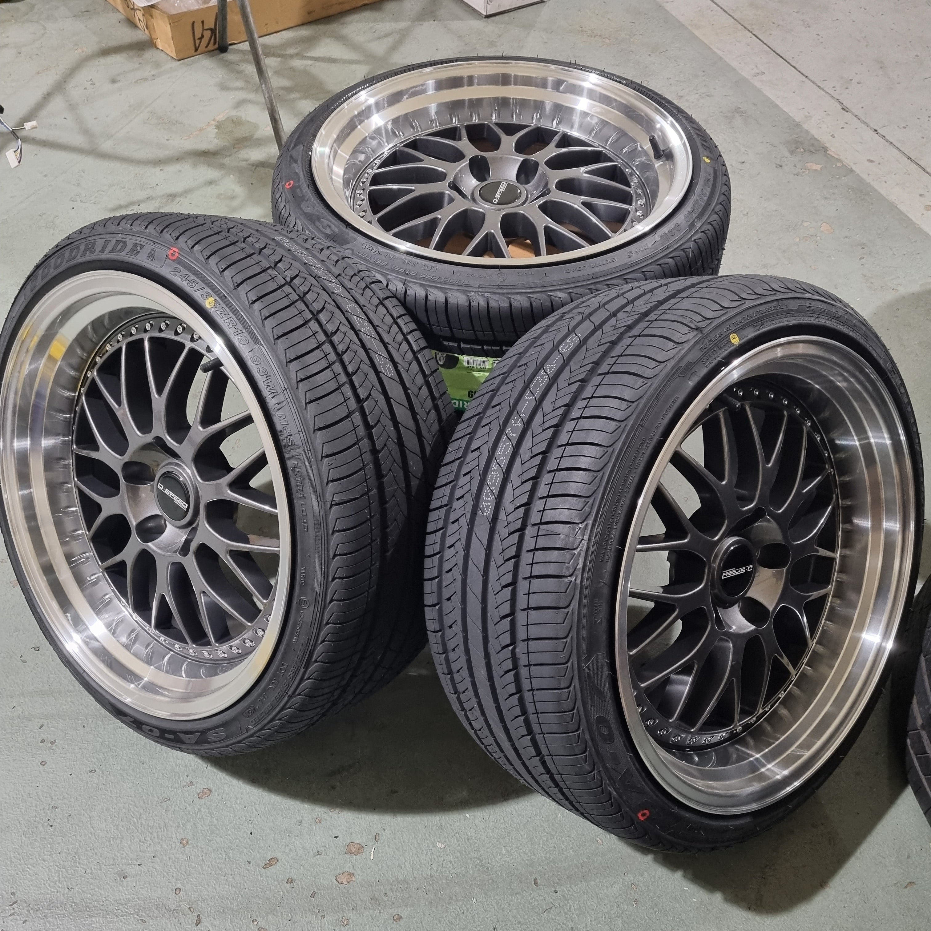 A set of four black D-Speed DS-06 wheels with tyres fitted on them, ready for mounting on a car.
